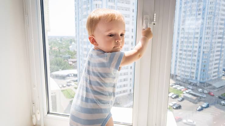 Child trying to open window